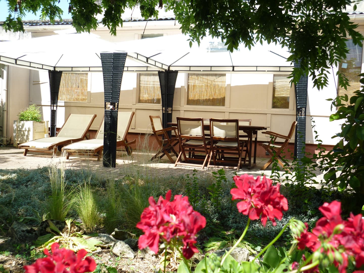 Vue extérieure de l'hôtel Clos Sainte Marie avec son jardin fleuri